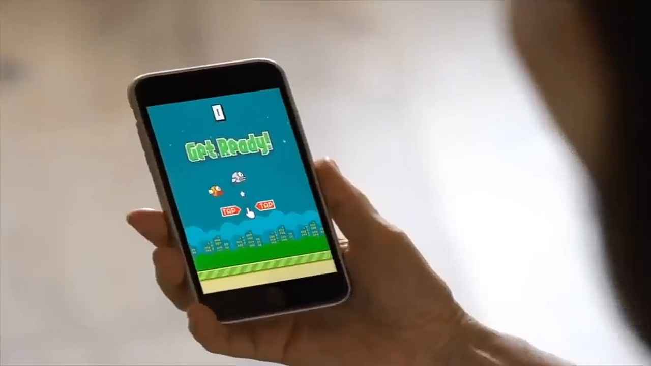 An image of a woman holding Flappy Bird